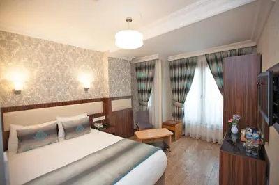 a hotel room with a bed and a television at Hotel Bulvar Istanbul in Istanbul