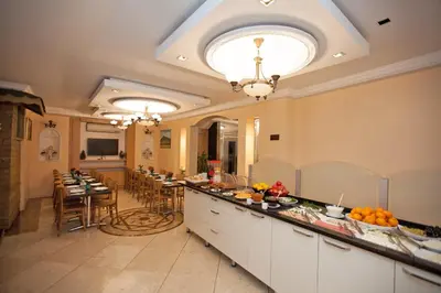 a large kitchen and dining room with a table and chairs at Hotel Bulvar Istanbul in Istanbul