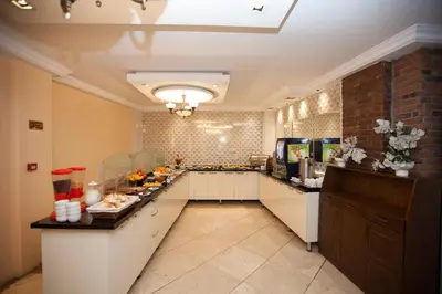 a large kitchen with a long counter in a room at Hotel Bulvar Istanbul in Istanbul