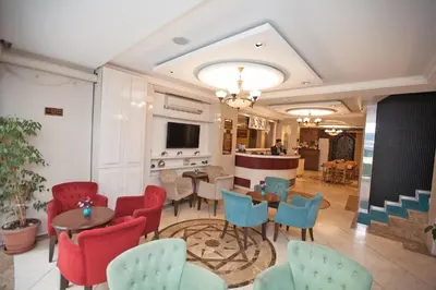 a lobby with tables and chairs and a bar at Hotel Bulvar Istanbul in Istanbul