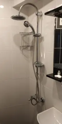a shower head in a bathroom next to a sink at Seahouse Suites in Istanbul