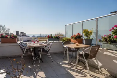 a patio with tables and chairs on a balcony at Feyza Apart in Istanbul