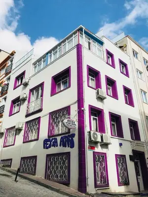 a white and purple building with windows on a street at Feyza Apart in Istanbul