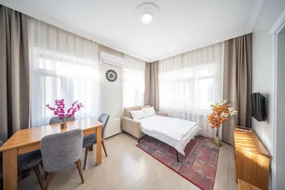 a room with a desk and a bed and a table at Feyza Apart in Istanbul