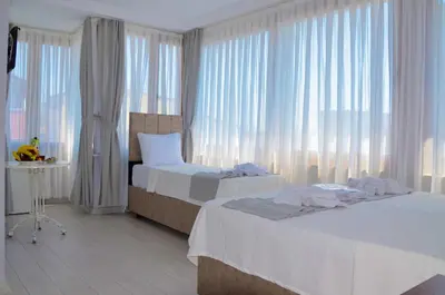 a hotel room with two beds and a window at Hotel Yasmin in Istanbul