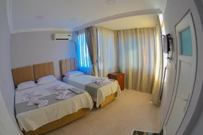 two beds in a hotel room with pink towels at Hotel Yasmin in Istanbul