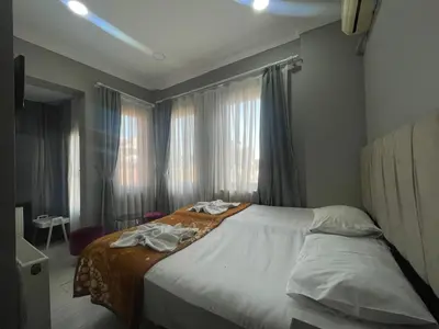 a bedroom with a bed with towels on it at Hotel Yasmin in Istanbul