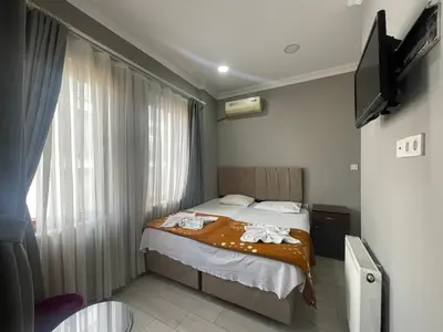 a bedroom with a bed and a window with a television at Hotel Yasmin in Istanbul