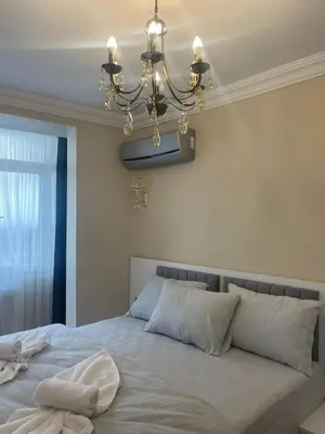 a bedroom with a large bed with a chandelier at Blue Mosque Apart in Istanbul