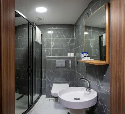 a bathroom with a sink and a shower and a toilet at Ista Palace Hotel in Istanbul