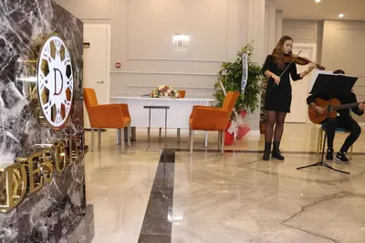a woman playing a violin and a man playing a guitar at DES'OTEL in Tekirdag