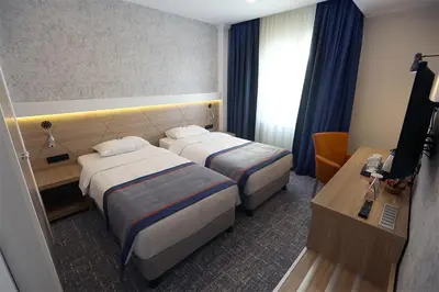 a hotel room with two beds and a television at DES'OTEL in Tekirdag