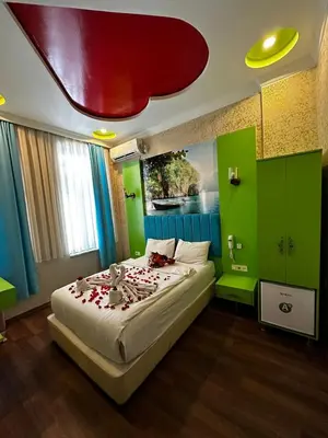 a bedroom with a large bed with roses on it at Hotel Megaron in Istanbul