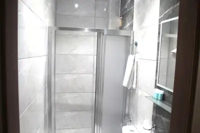 a bathroom with a shower with a glass door at Hotel Megaron in Istanbul