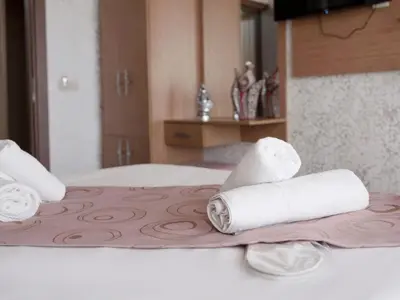 a hotel room with two rolls of toilet paper on a bed at Hotel Megaron in Istanbul