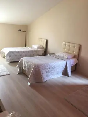 a bedroom with two beds with white sheets at Hotel Eken Prestige in Bandırma