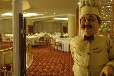 a statue of a chef standing in a restaurant at Hotel Eken Prestige in Bandırma