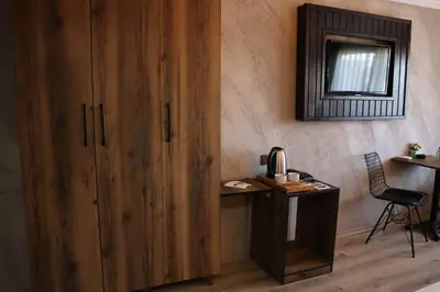 a room with a wooden cabinet and a desk with a chair at Insta Hotel Karakoy in Istanbul