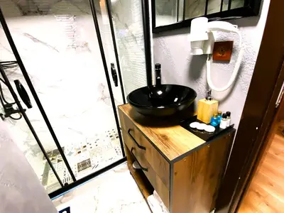 a bathroom with a black sink and a shower at Insta Hotel Karakoy in Istanbul