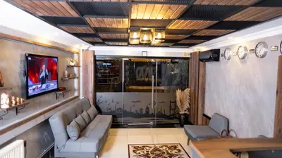 a living room with a couch and a tv at Insta Hotel Karakoy in Istanbul