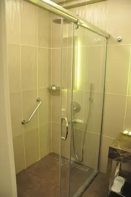 a shower with a glass door in a bathroom at Centrum Suites İstanbul in Istanbul