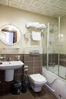 a bathroom with a toilet and a sink and a shower at Vatan Asur Hotel in Istanbul