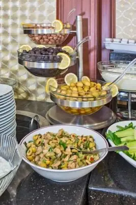 a buffet with a bowl of food on a table at Vatan Asur Hotel in Istanbul