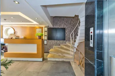 a lobby with a staircase in a building at Erbazlar Hotel in Istanbul
