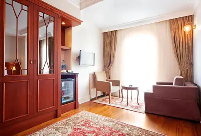 a living room with a door and a couch and a table at Aren Suites in Istanbul
