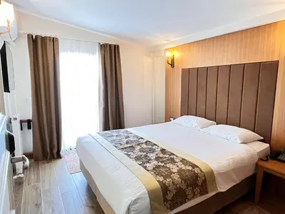 a hotel room with a large bed and a window at Aren Suites in Istanbul