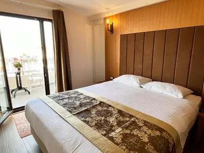 a bedroom with a large bed with a large window at Aren Suites in Istanbul