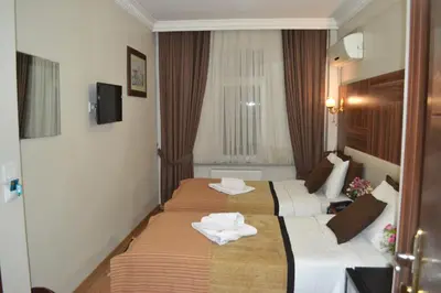 two beds in a hotel room with towels on them at Grand Fatih Hotel in Istanbul