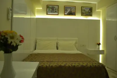 a bedroom with a bed and a vase with flowers at Grand Fatih Hotel in Istanbul