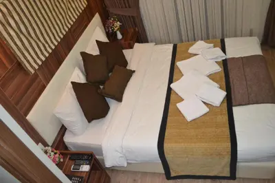 a bed with pillows and towels on it in a room at Grand Fatih Hotel in Istanbul