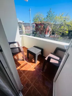 a balcony with two chairs and a table on a roof at Aycan Sultan Apart Hotel in Istanbul