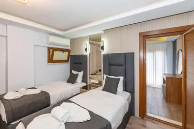 a hotel room with two beds and a bathroom at T-Square Residence in Istanbul