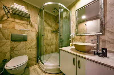 a bathroom with a toilet and a sink and a shower at Asia Business Suites in Istanbul