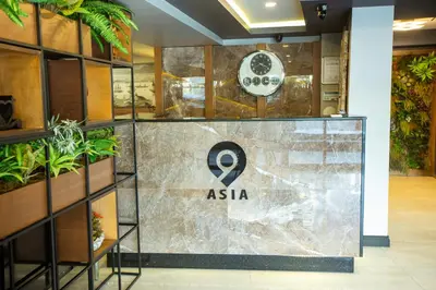 a sign for asia in a lobby with plants at Asia Business Suites in Istanbul
