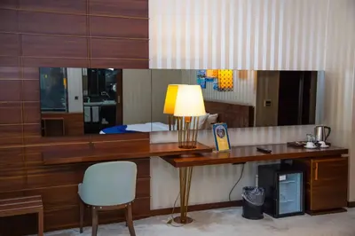 a desk with a lamp and a chair in a room at Gold Majesty Hotel in Bursa