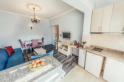 a kitchen and a living room with a table at Olive Garden Apart in Istanbul