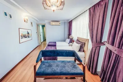 a living room with a couch and a chair at Olive Garden Apart in Istanbul