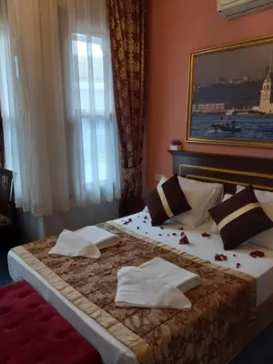 a bedroom with a bed with towels on it at Emirhan Hotel, Sultanahmet in Istanbul