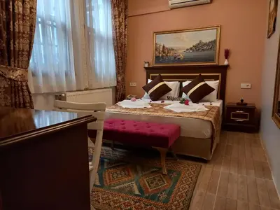 a hotel room with a bed with a red bench at Emirhan Hotel, Sultanahmet in Istanbul