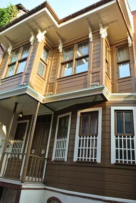 a yellow house with white windows at Emirhan Hotel, Sultanahmet in Istanbul