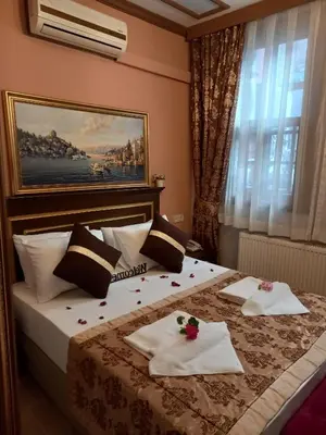 a hotel room with a bed with towels on it at Emirhan Hotel, Sultanahmet in Istanbul