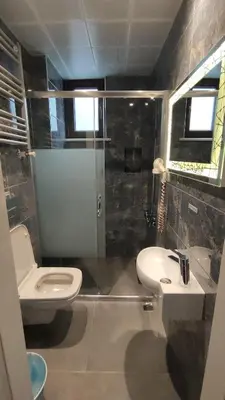 a bathroom with a toilet and a sink and a shower at Hotel Torun Istanbul Old City in Istanbul