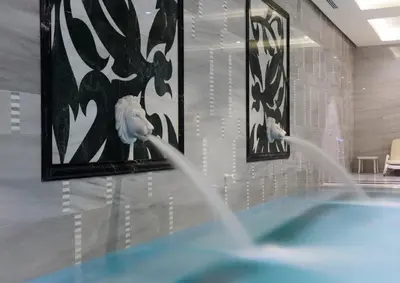 a water fountain in a room with paintings on the wall at Crowne Plaza Bursa Convention Center & Thermal Spa by IHG in Bursa