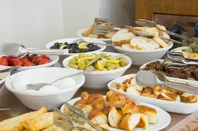 a table topped with bowls of different types of food at Lalinn Hotel in Istanbul