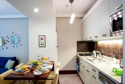 a kitchen with a wooden table and a dining room at 116 Residence in Istanbul