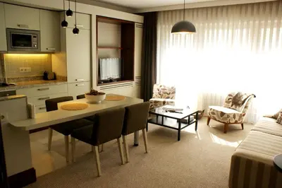 a kitchen and living room with a table and chairs at 116 Residence in Istanbul